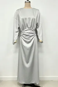 Front view of an elegant silver satin pleated long dress displayed on a mannequin
