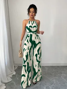 Detailed look at the green abstract print and halter design of this wide-leg jumpsuit.