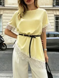 Close-up detail of French yellow satin top featuring delicate white lace trim and belt.