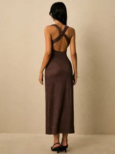 Back view of brown ribbed midi dress featuring elegant open back with criss-cross straps