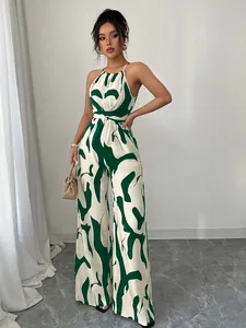 Stylish women's halter neck wide-leg jumpsuit with green and white abstract print