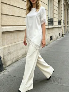 Elegant white satin t-shirt with delicate lace patchwork hem and sleeves in street view