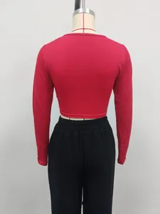 Back view of a tight red long-sleeved crop top on a mannequin showing fit and style