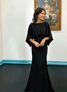 Elegant black pleated maxi dress for women featuring chic batwing sleeves and a slim fit.