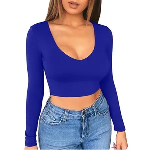 Detailed view of women's slim fit blue long sleeve crop top with low cut neckline