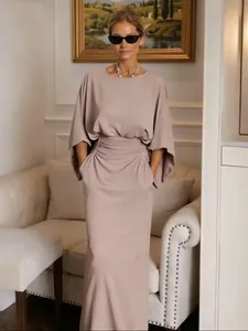 Elegant taupe maxi dress featuring ruched waist detail and convenient side pockets