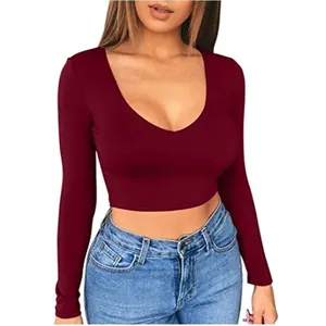 Detail view of tight-fitting maroon long-sleeved cropped T-shirt with deep V-neckline