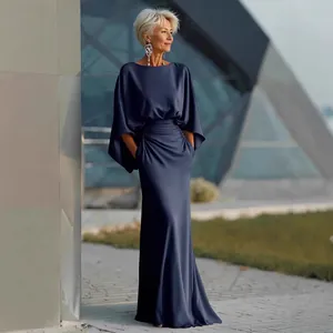 Elegant navy blue maxi dress featuring pleated waist, dolman sleeves, and side pockets.