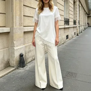 Elegant white satin lace top with matching wide leg pants in a French street setting
