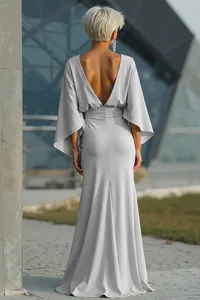 Back view of an elegant light grey backless maxi dress featuring wide sleeves and pleats