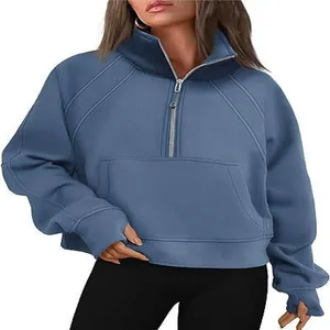 Detailed view of women's blue half-zip sweatshirt featuring stand collar and pocket