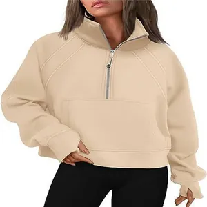 Detail view of beige half-zip women's sweatshirt featuring a stand collar and front pocket