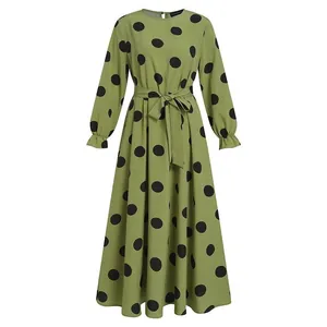 Elegant olive green long-sleeved maxi dress featuring black polka dots and tie belt