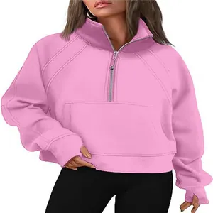 Detailed view of pink half-zip sweatshirt featuring a stand collar and thumbhole sleeves