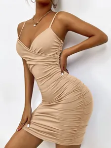 Side view detail showing the ruched fabric of this beige bodycon spaghetti strap dress