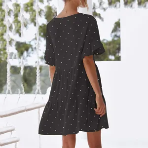 Detailed back view of a black polka dot short dress with ruffled sleeves and tiered skirt