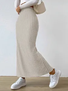 A side view showing the ribbed texture of a high-waisted slim fit knit maxi skirt