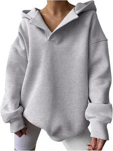 Detailed close-up of grey oversized hoodie showing the ribbed cuffs and collar.