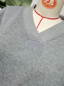 Close-up of the V-neckline and fabric texture on a grey oversized sweatshirt