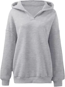 Close-up of a grey loose hooded sweatshirt with a V-neck detail and ribbed cuffs.