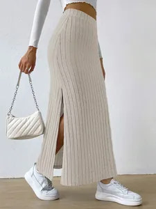 Detail view of a high-waisted ribbed knit maxi skirt with side slit