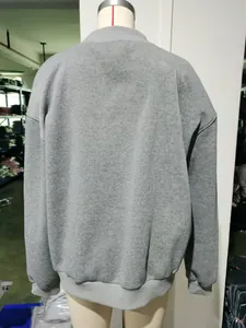 Detailed back view of a grey oversized long sleeve crew neck sweatshirt on a torso mannequin