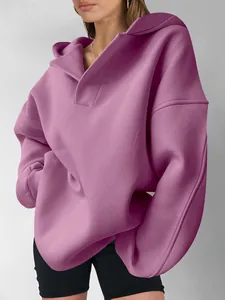 Close-up detail of a purple oversized hooded sweatshirt featuring a polo collar and soft fleece fabric