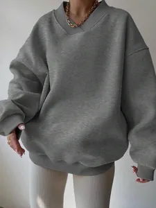 Detailed view of an oversized grey sweatshirt featuring a unique ribbed v-neck collar.