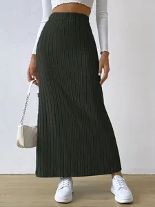 Full length view of elegant high-waisted ribbed knitted maxi skirt in dark grey