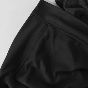 Close-up detail showing the high-quality stitching and texture of black hooded jacket