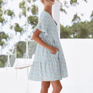 Side view of light blue summer dress featuring cherry print and ruffled sleeve details