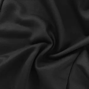 Detailed macro view of the black textured woven fabric showing soft folds and weave.