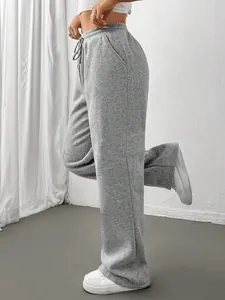 Detail view of women's thick high waist grey sports sweatpants with adjustable drawstring waist.