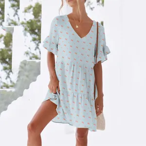 Detailed view of women's light blue V-neck short-sleeved dress with cute cherry patterns