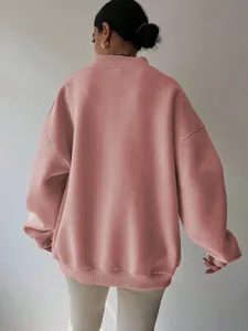 Back view of a minimalist oversized dusty pink sweatshirt for women, loose casual style