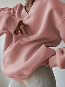 Detail shot of oversized dusty pink V-neck sweatshirt with ribbed cuffs and collar