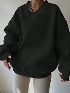 Detailed view of oversized black long-sleeve sweatshirt featuring V-ribbed neckline design