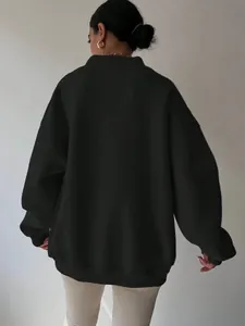 Back view of oversized black long-sleeved sweatshirt for women with stylish ribbed trim