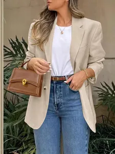 Elegant British style long sleeve beige blazer outfit for women with jeans and handbag