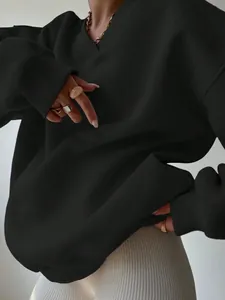 Detail shot of black oversized V-neck long sleeve sweatshirt with ribbed texture