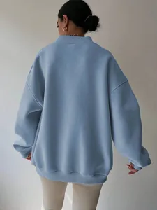Back view of a premium loose-fit light blue sweatshirt with ribbed cuffs and a cozy hem.