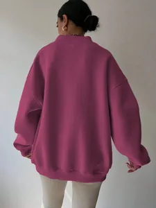 Back view of a magenta oversized sweatshirt showing its loose fit and premium fabric texture.