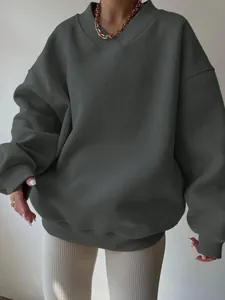 Detail view of an oversized dark grey V-neck sweatshirt for casual women's wear