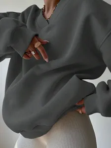 Detailed view of a dark grey oversized V-neck sweatshirt with soft fabric texture