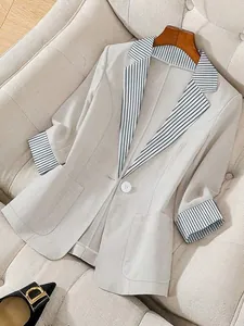 Chic beige women's blazer with classic striped contrast lapels and cuffs in British style