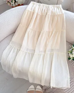Elegant cream-white tiered maxi skirt with lightweight pleated fabric and elastic waist