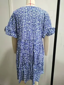 Back view of casual blue and white floral summer dress with ruffle sleeves on mannequin