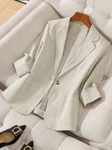 Detail view of a linen-textured light beige blazer for women with a single button
