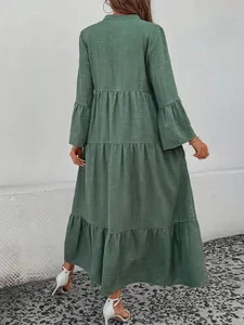Detailed back view of a forest style sage green tiered maxi dress with textured fabric