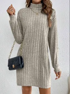 Detail view of stylish grey ribbed knit turtleneck midi dress featuring cozy fabric